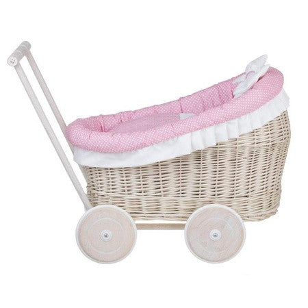 close-up of the charming whitewashed wicker doll pram with soft pink bedding and intricate handwoven texture