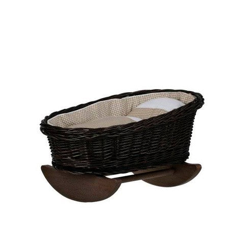 elegant wicker doll cradle with beige checkered bedding in soft morning light