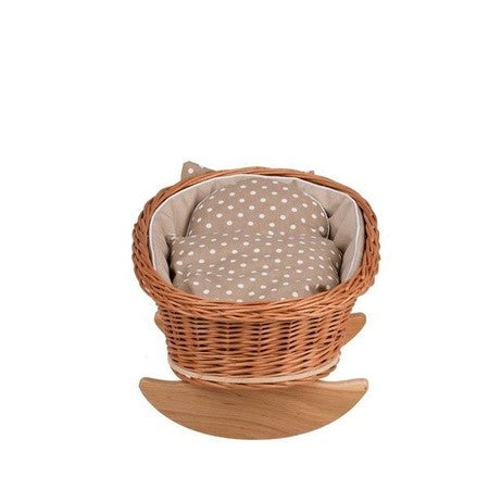bold statement piece - a natural wicker rocking cradle with beige bedding for imaginative play