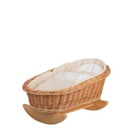 a gentle wicker cradle with soft white bedding, ready for a doll to be tucked in