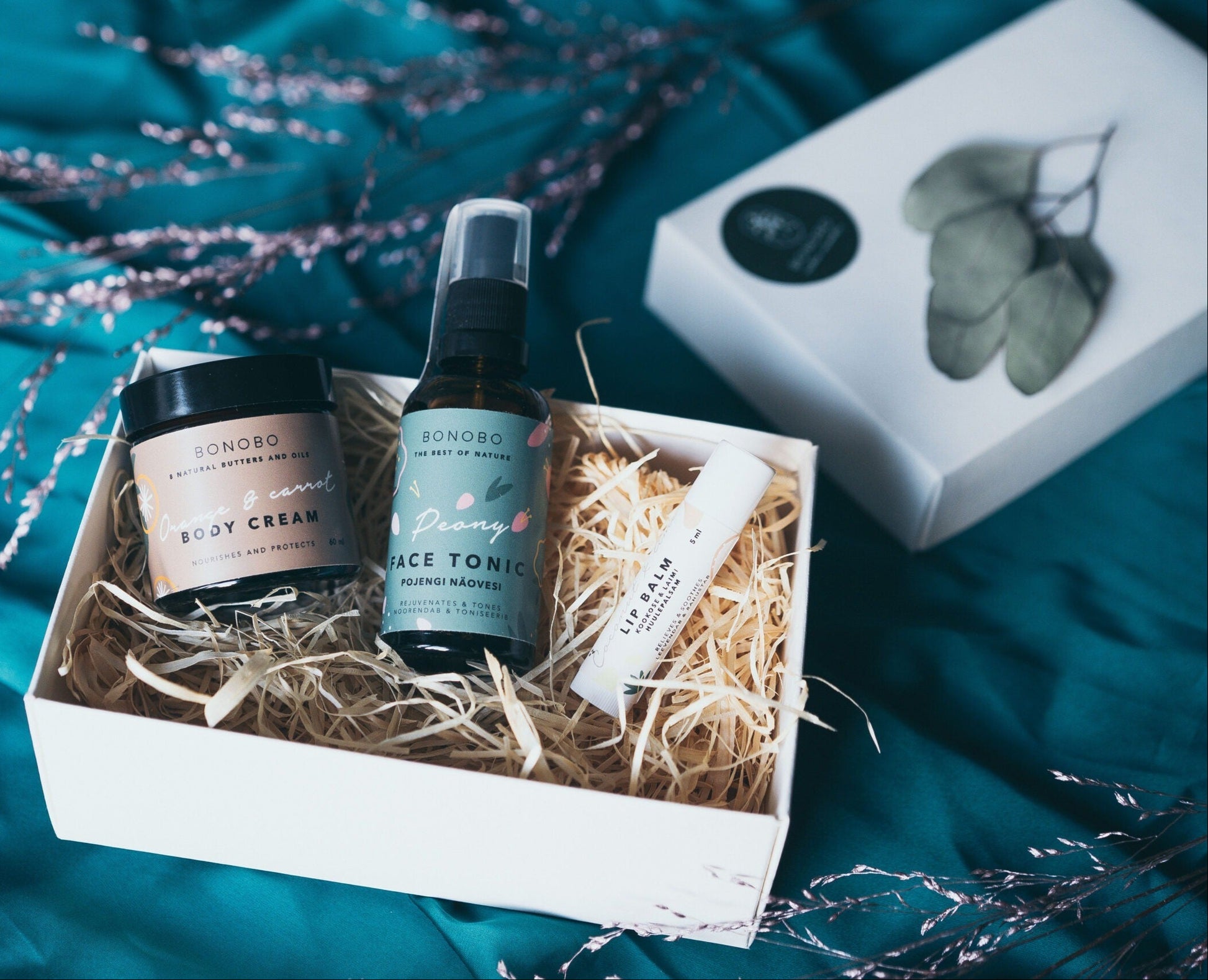 bold modern leather gift box open to reveal botanical tonic and citrus cream