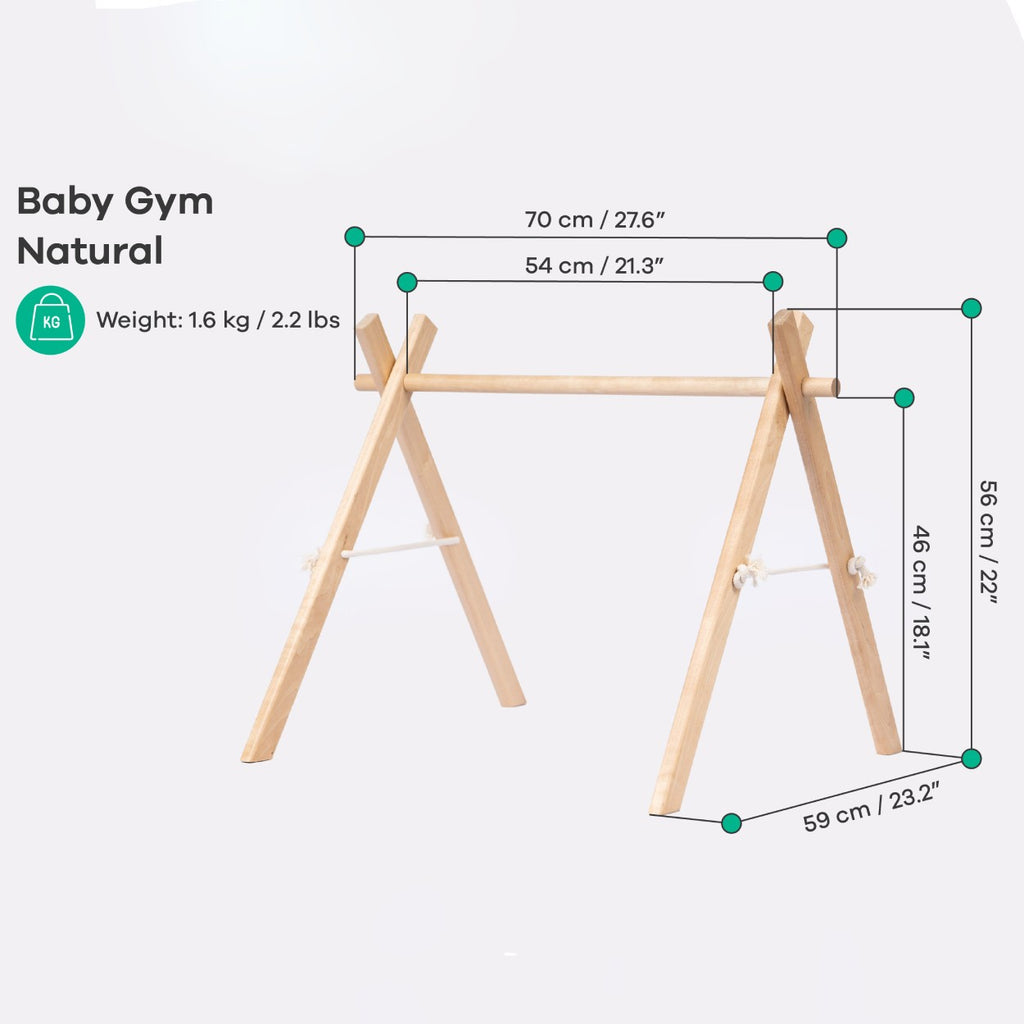 a soft-focus side view of the wooden baby gym with gentle morning light highlighting its natural grain