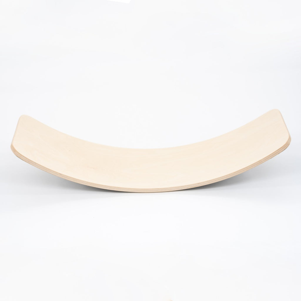 a modern wooden balance board in an elegant home setting, showcasing its refined scandinavian curves