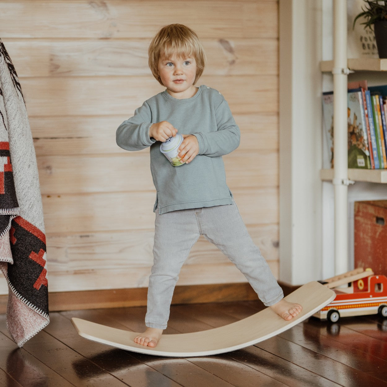 a bold, low-angle shot of a modern wooden balance board on a minimalist background