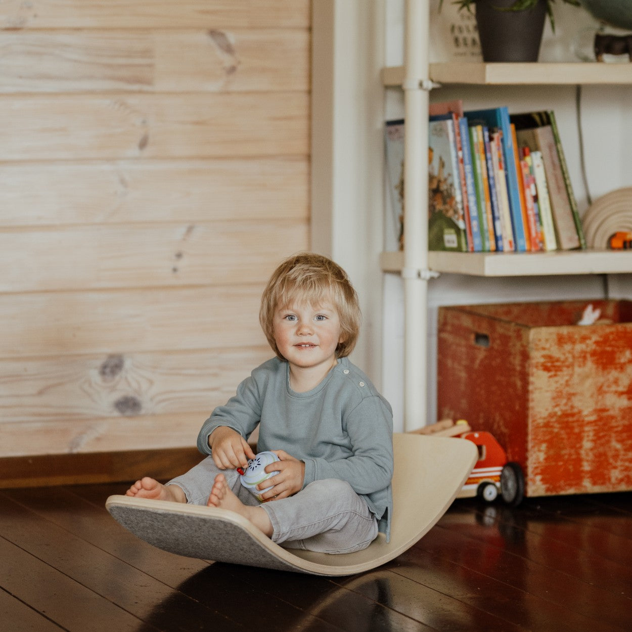 elegant wooden balance board with grey felt, displayed as a minimalist sculpture in a modern living space