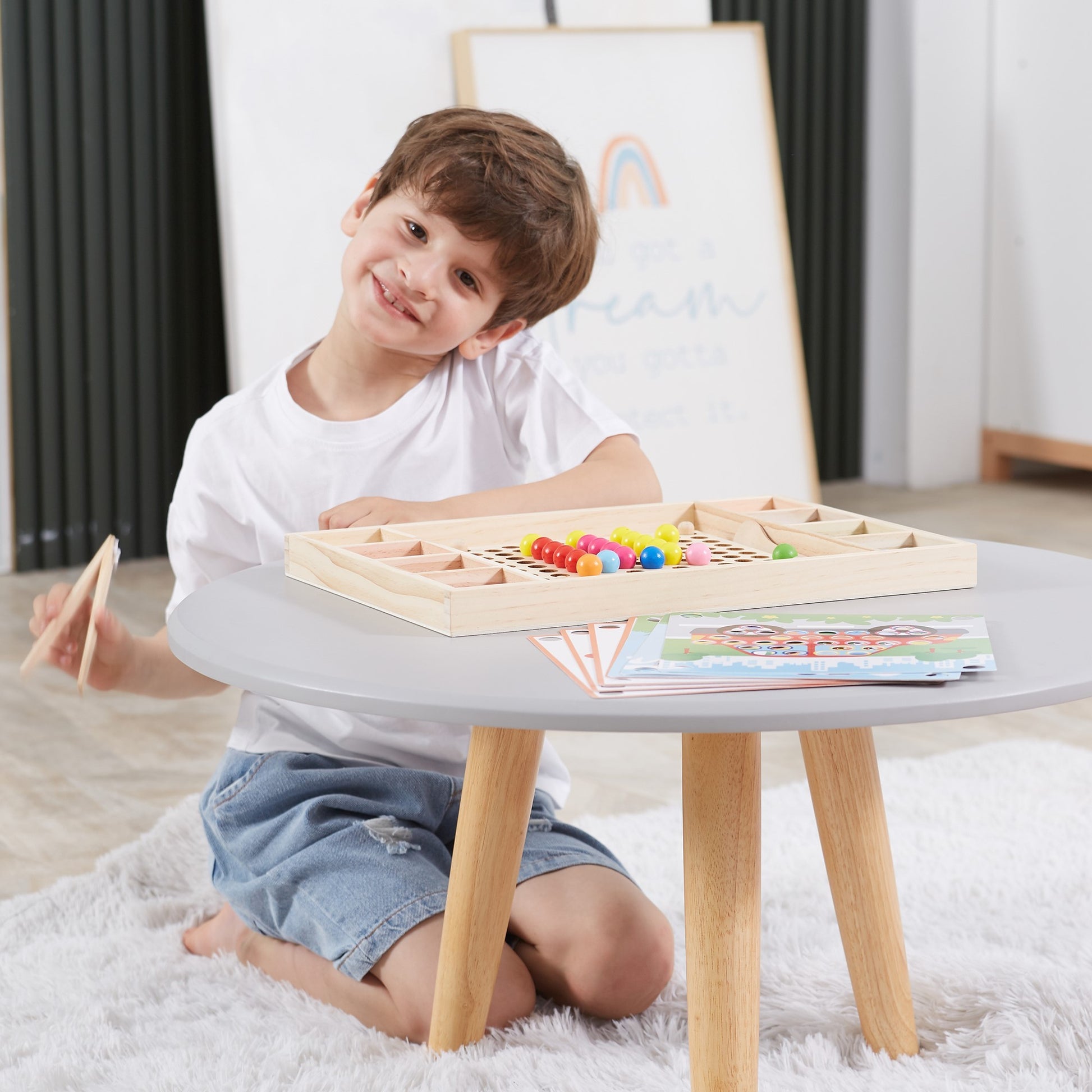 playful wooden catch and match montessori puzzle with bright beads and tools on a sunny table