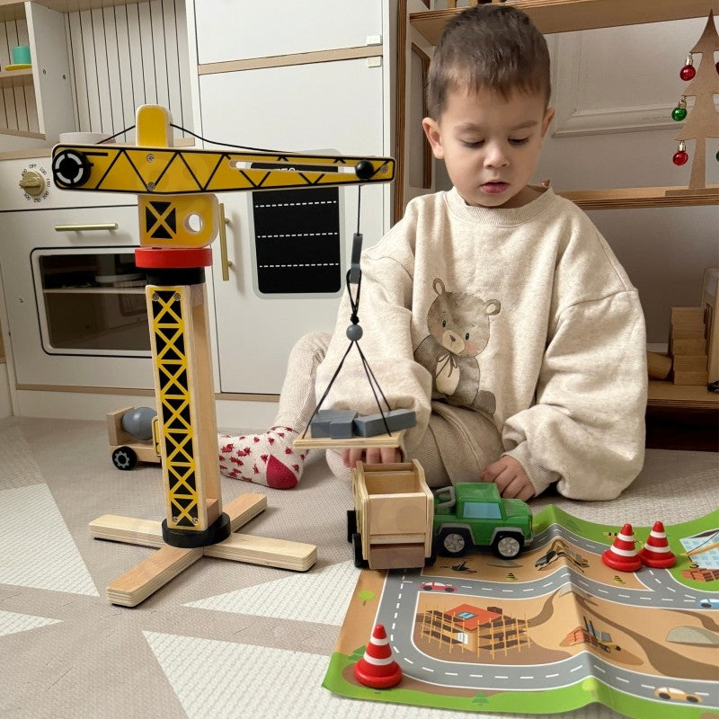 close-up of a child's hands lifting a wooden block with the woopie green crane