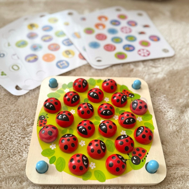 elegant close-up of artisan-made ladybug memory puzzle on a minimalist background