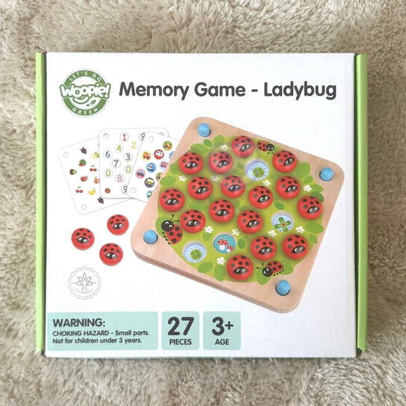 a child's hand placing a vibrant ladybug memory tile on a sunlit wooden puzzle board