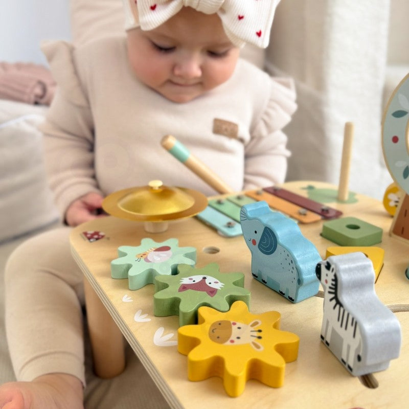 elegant close-up of the woopie green activity table's sustainable wooden xylophone and gear spinner