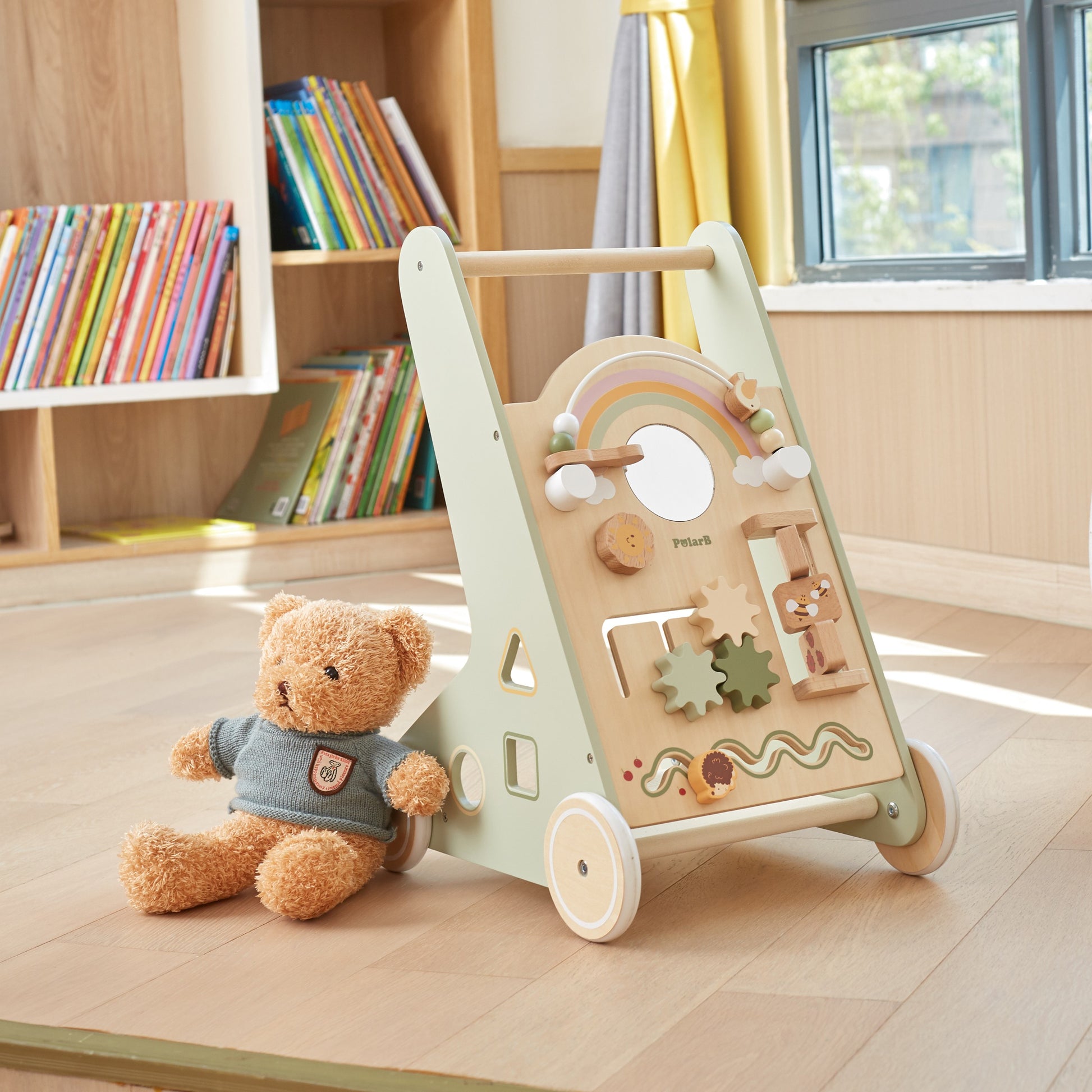 bold green wooden walker with spinning wheels and rainbow beads for toddler development