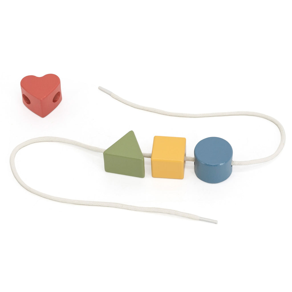 soft pastel wooden toy set for toddlers with xylophone, block puzzle, and threading activity on a cozy rug