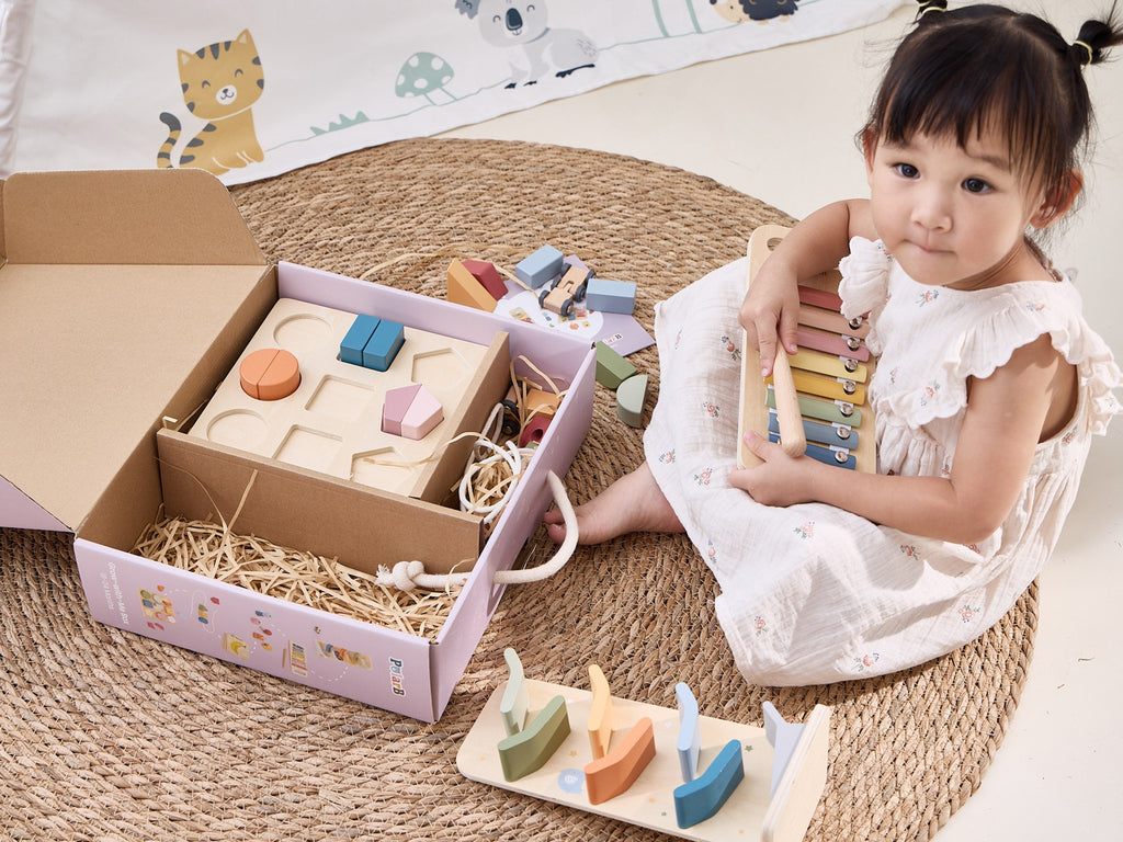wooden educational toy set with xylophone and threading activity in soft pastel colors for toddlers