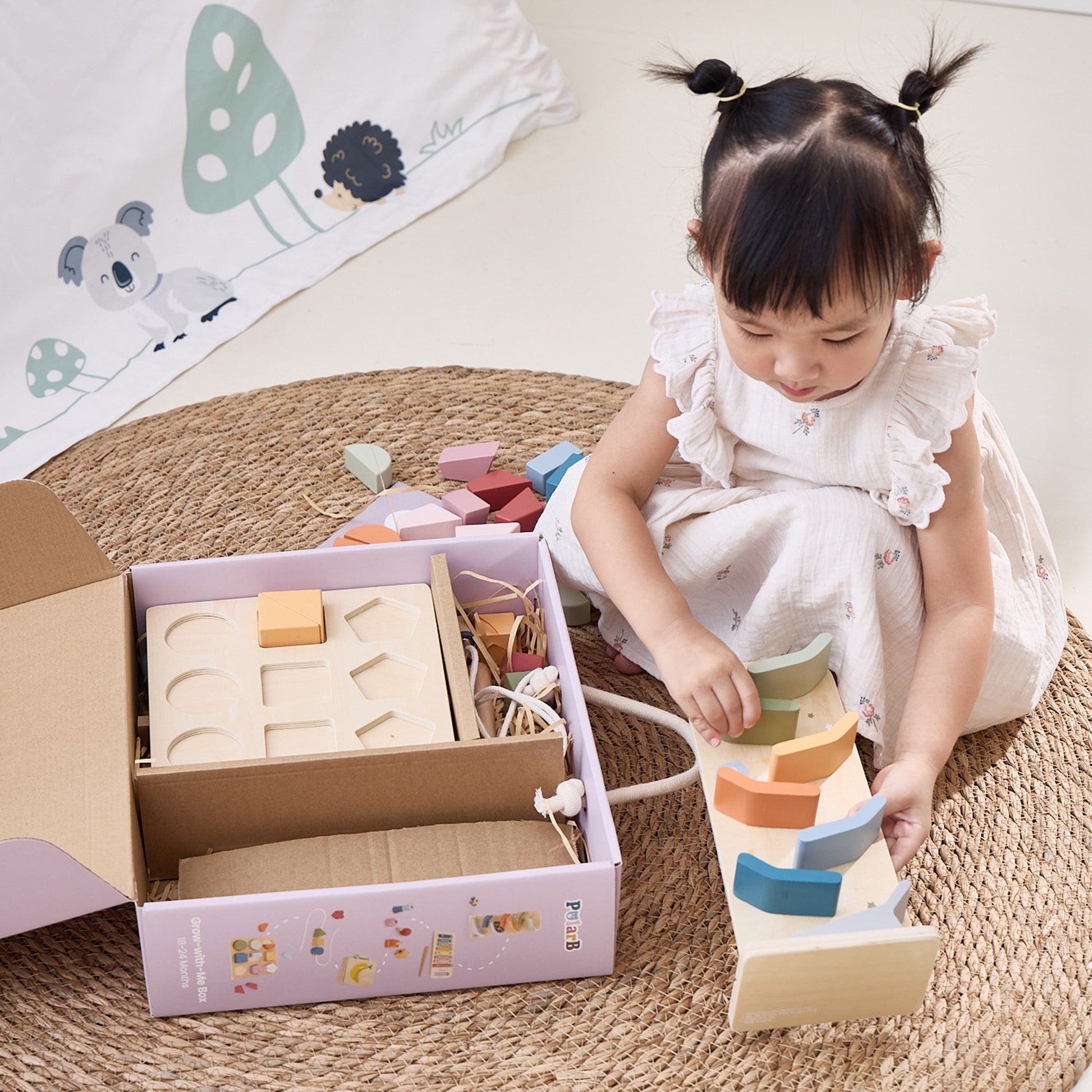 wooden educational toy set with xylophone, block puzzle, and threading activity in soft pastel colors for toddlers