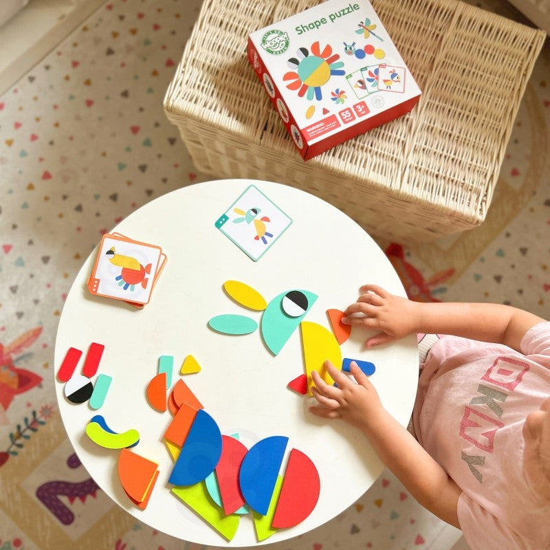 child's hand placing a wooden butterfly shape onto a vibrant montessori puzzle board