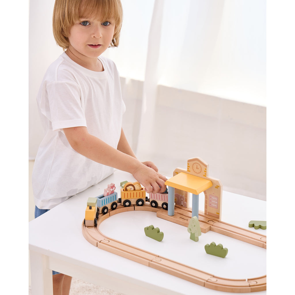 wooden train set with xylophone and threading activity for toddlers, soft pastel colors on wooden table